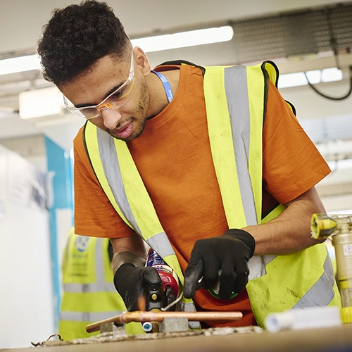 A student sketching at a desk