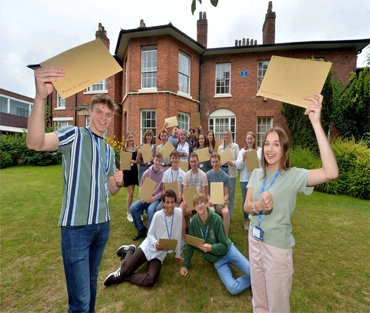 Group of students outside Welsh Bridge Campus holding envelopes