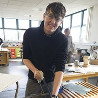 Student sawing metal