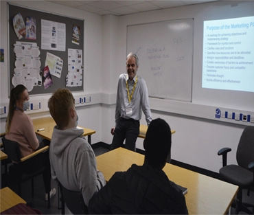 Jon Hepburn talking to a classroom of students