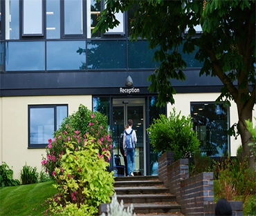 Student walking into reception at London Road Campus