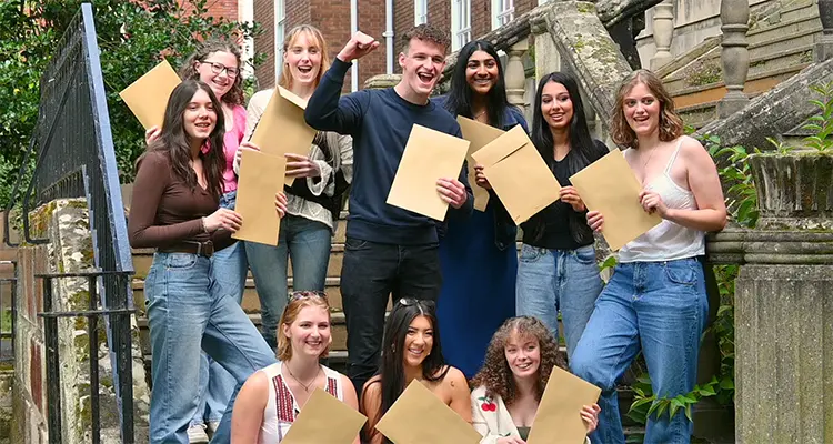 A group of college students holding their results