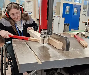 Helen Docker using machinery on Carpentry course