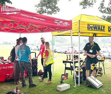 A group of people standing at a supplier stand