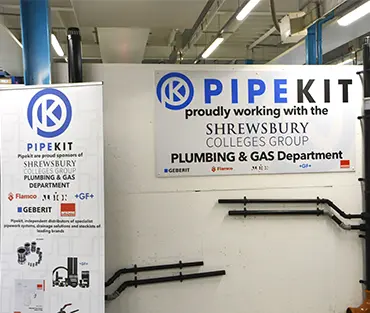 Sign and banner showing PipeKit and SCG logo