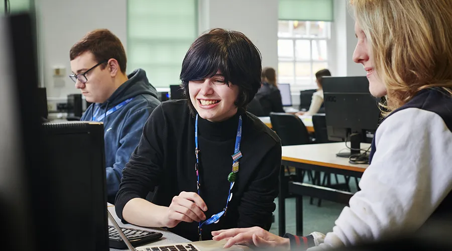 Student and teacher looking at computer screen