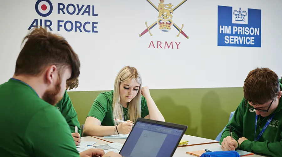 Students at desk writing