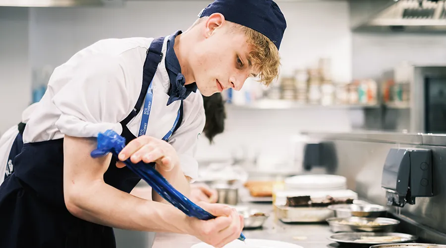 Students piping sauce to meal